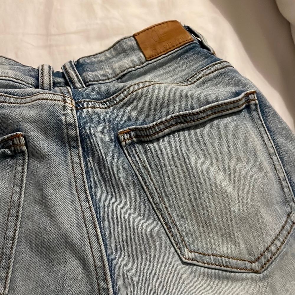 Crysp. denim light blue ripped shorts red/white race car strip on the side